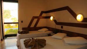 A hotel room with two beds, a large window, and a wall-mounted light fixture. - Serra Negra Paladium Hotel (Serra Negra)