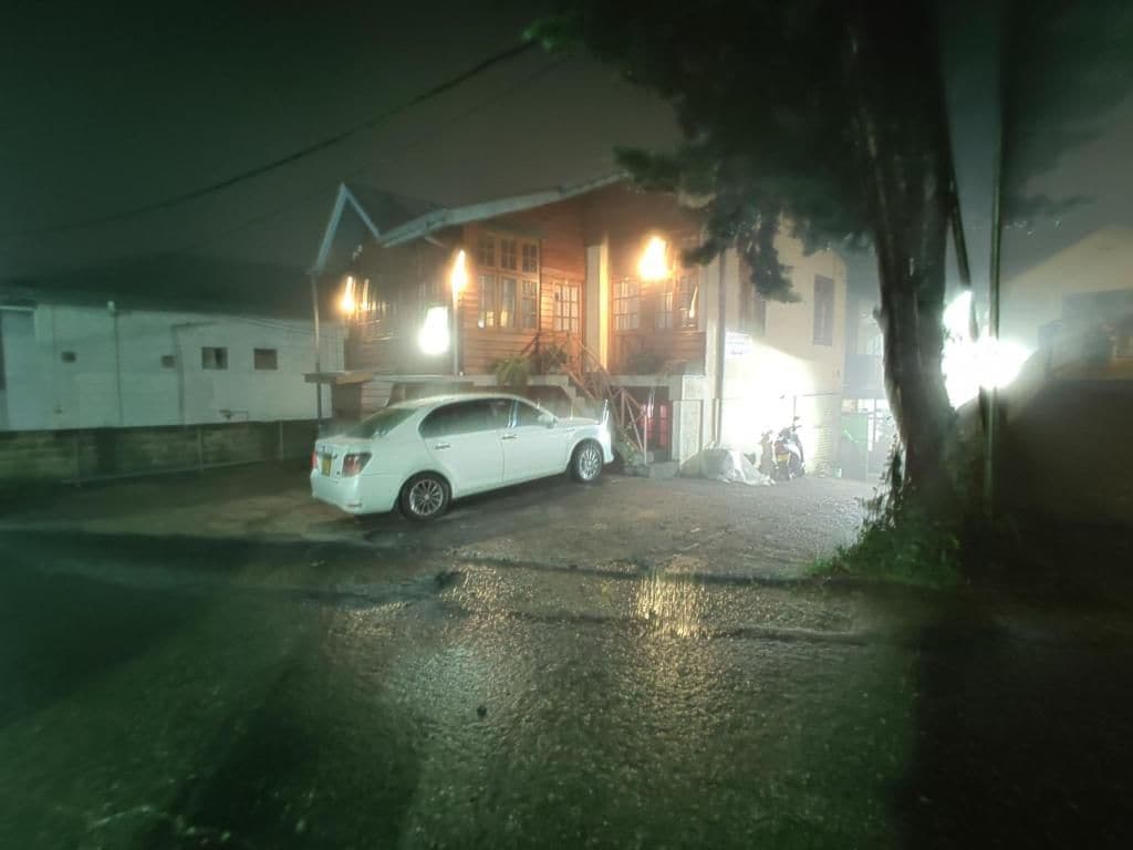 A building with a car parked in front.