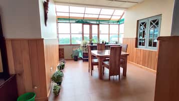 Basic Triple Room, 1 Bedroom | Living area | 32-inch flat-screen TV with cable channels, TV