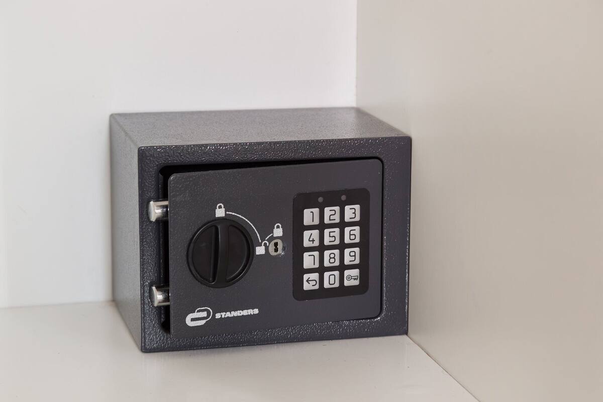 A black safe with a numeric keypad and a keyhole lock.