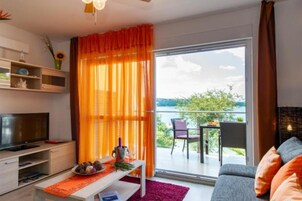 Executive Three Bedroom Apartment, Balcony, Sea view | Living area | Flat-screen TV, DVD player
