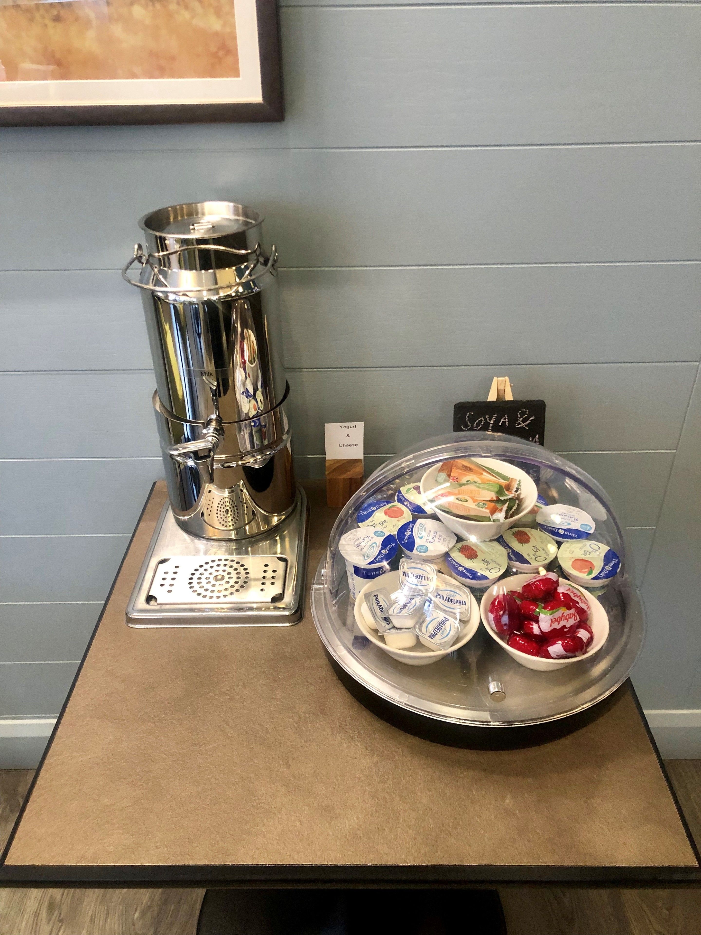 A coffee machine and a yogurt display on a counter.