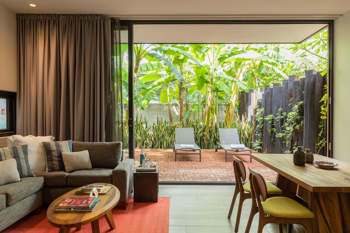 A modern living room with a sofa, coffee table, and dining area.