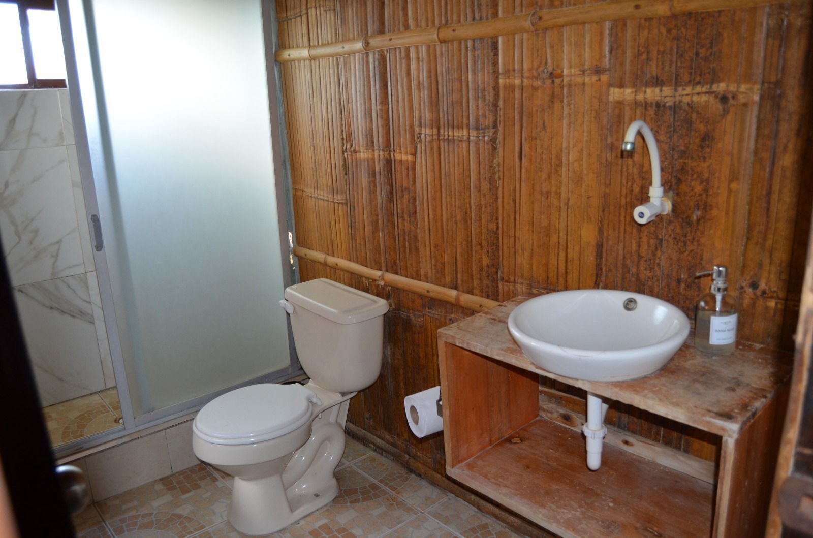 A bathroom with a toilet, a sink, and a shower.
