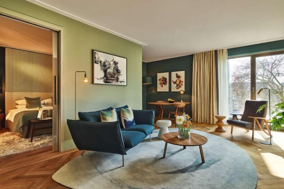 A modern living room with a sofa, coffee table, and artwork on the walls.