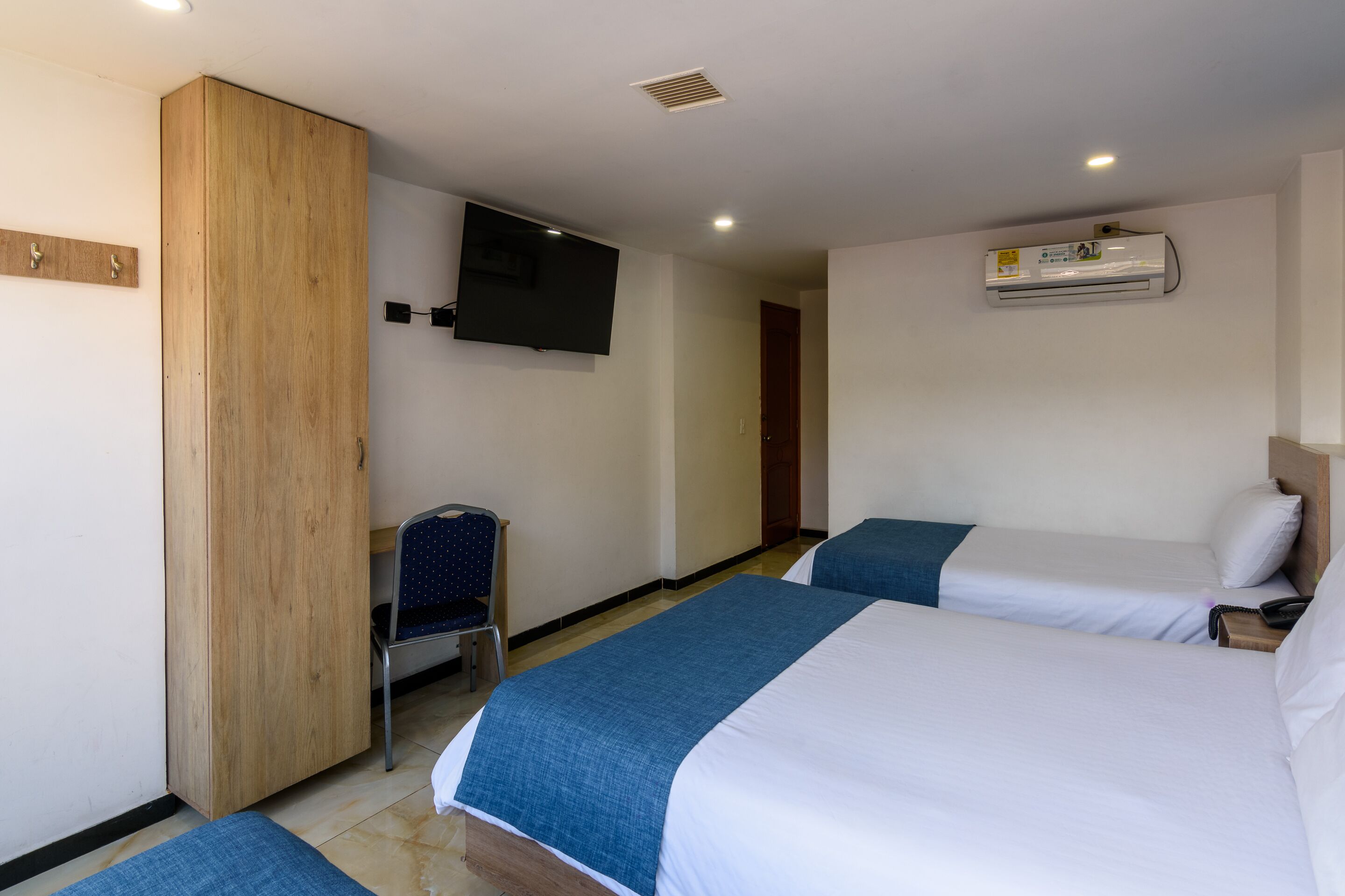 triple room | premium bedding, desk, laptop workspace, iron/ironing board