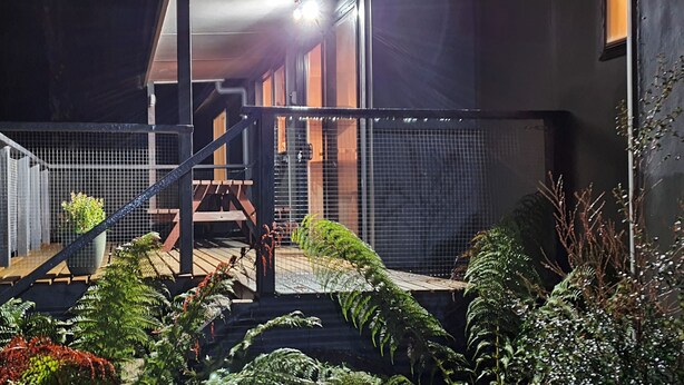 A staircase leading to a balcony with a view of a building.