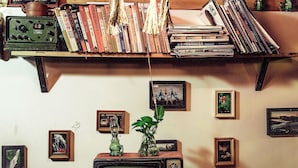 A room with a wooden shelf holding books and a television set on a wooden table. - Zhangjiajie Wang Yi Inn (Zhangjiajie)