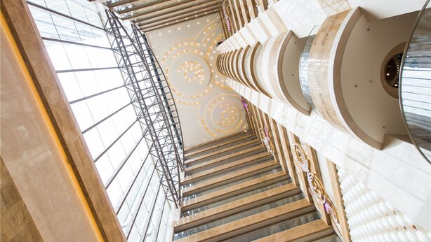 A multi-level atrium with a central spiral staircase, large windows, and decorative lighting. - Landison Plaza Hotel Ningbo (Ningbo)