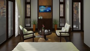 A modern living room with a large TV, two sofas, a coffee table, and a fireplace. - Little Town Villa (Da Nang)