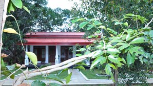 A building with a red roof and white columns, surrounded by greenery. - Winmi Resort (Habarana)