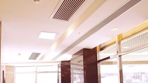 A modern lobby with leather sofas, large windows, and a polished wooden floor. - Grand Harbour Hotel (Macau)