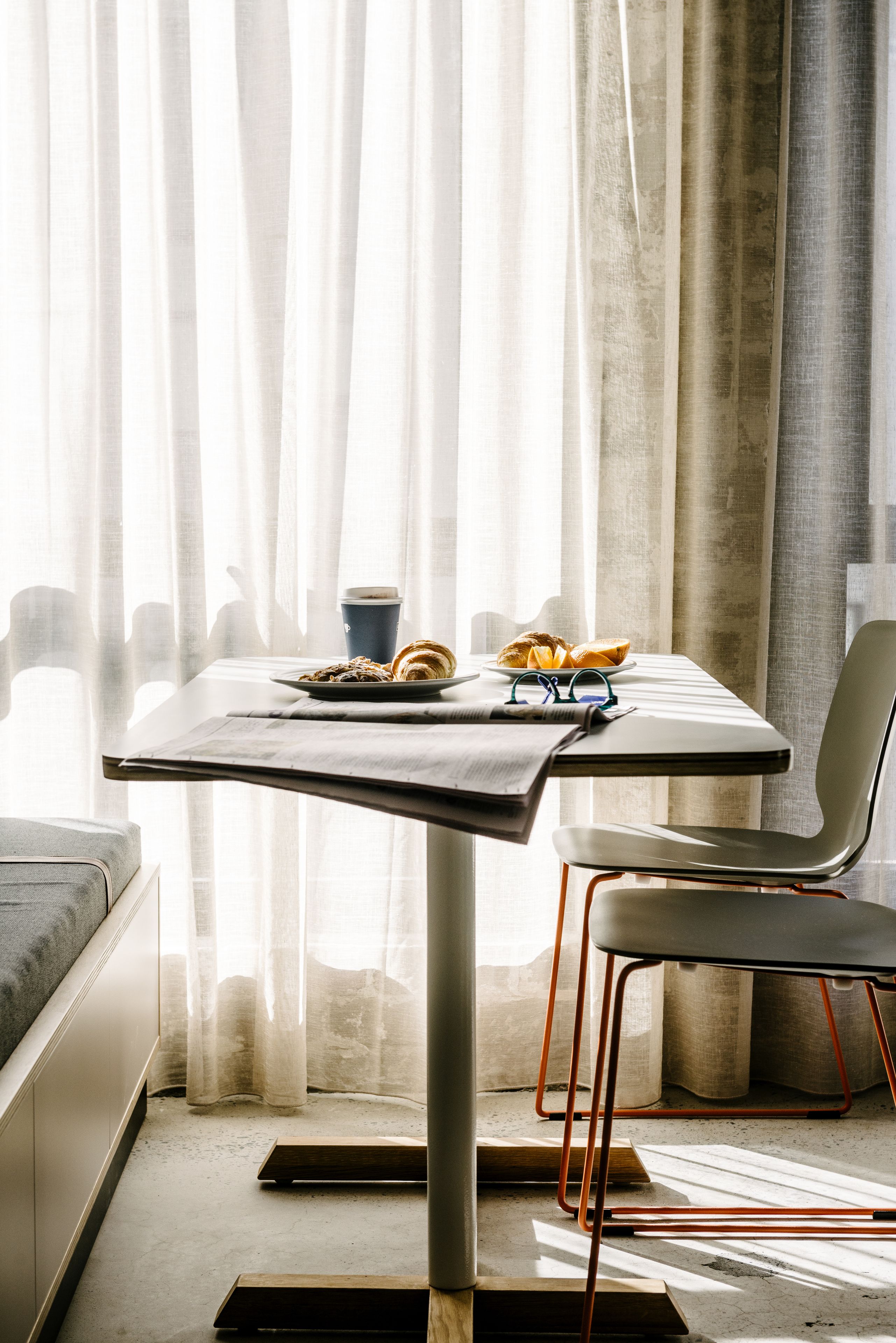 A dining area with a table, chairs, and a breakfast setting.