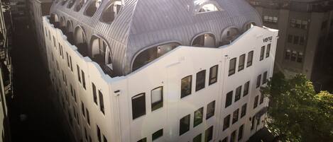 A modern building with a unique, curved roof and multiple arched windows.