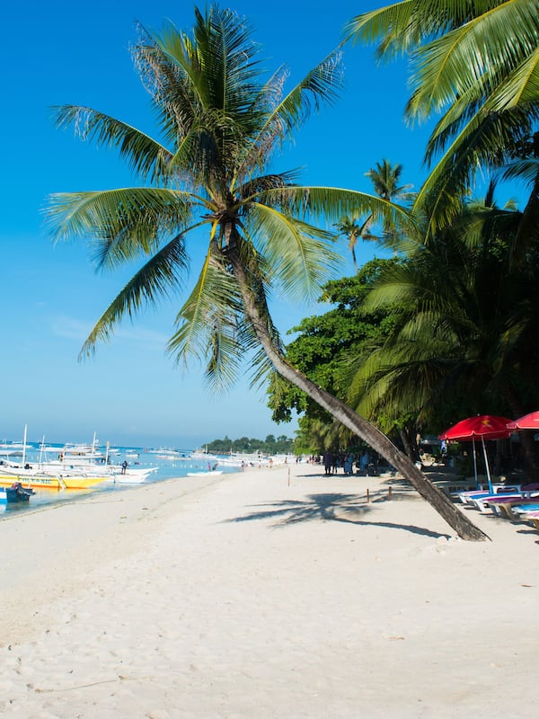 On the beach, white sand, sun loungers, beach umbrellas