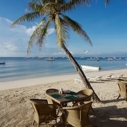 On the beach, white sand, sun loungers, beach umbrellas