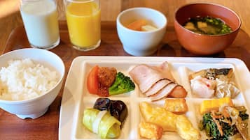 A meal tray with various dishes including rice, meat, vegetables, and soup.