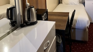 A hotel room with a bed, a desk with a coffee maker, a chair, a wardrobe, and a window with curtains. - Istanbul Paris Hotel & Hostel (Istanbul)