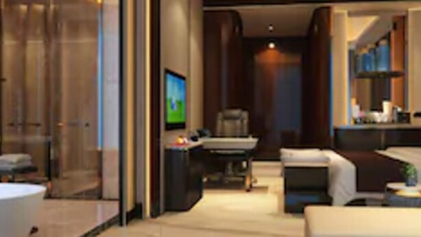 A modern hotel room with a glass partition, a flat-screen TV, a sofa, and a desk. - Wuhan You Yi International Hotel (Wuhan)