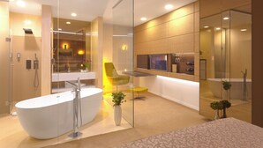 A modern bathroom with a freestanding bathtub, a glass shower enclosure, and a vanity with a mirror. - Hotel Vila Class (Satu Mare)