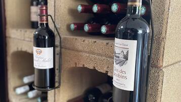 A wine rack with bottles of wine, including a bottle labeled "Clos des Jacobins 2013."