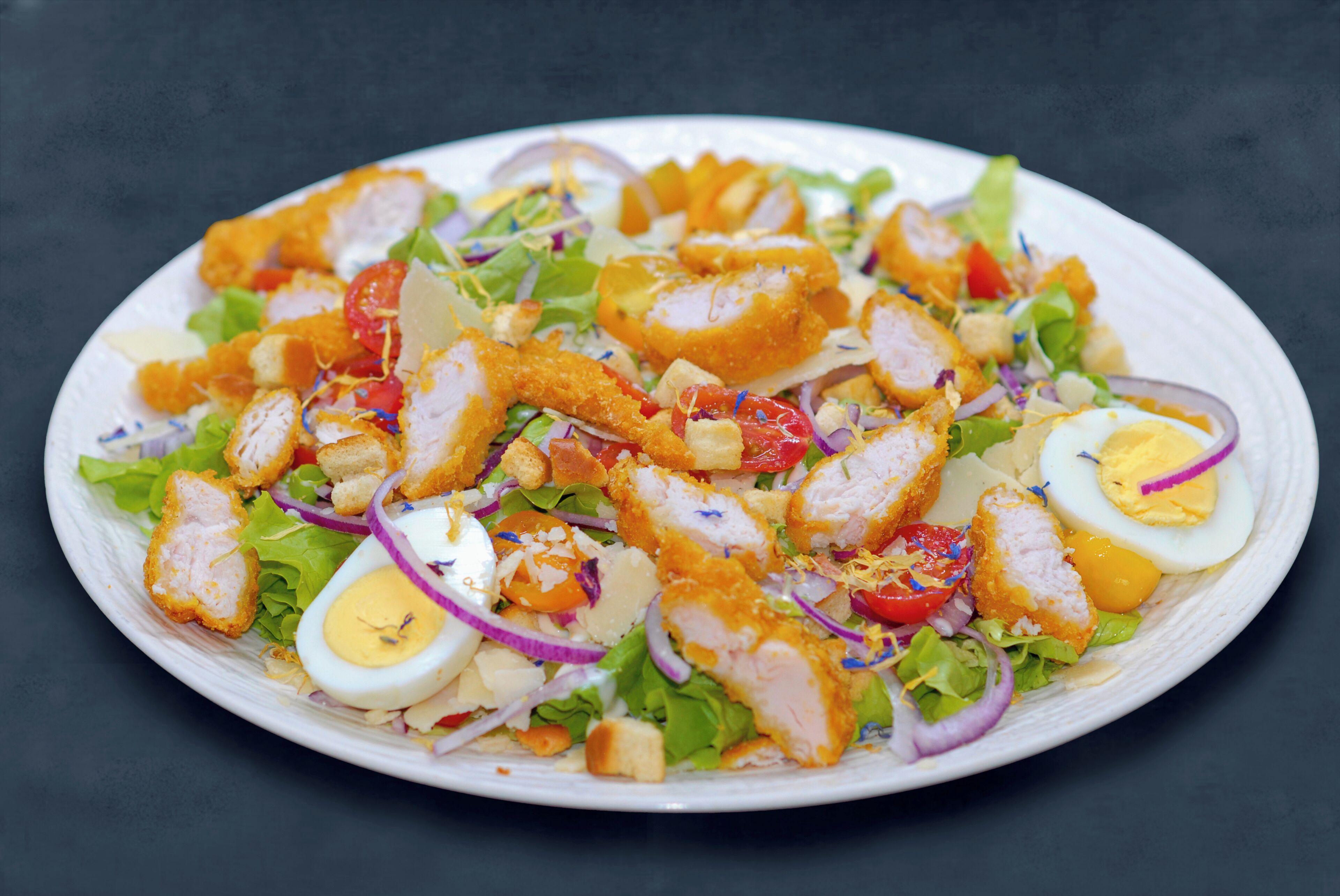 A plate of salad with various ingredients.