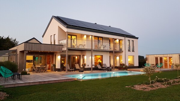 Relax in the spacious outdoor area with a swimming pool and patio seating.