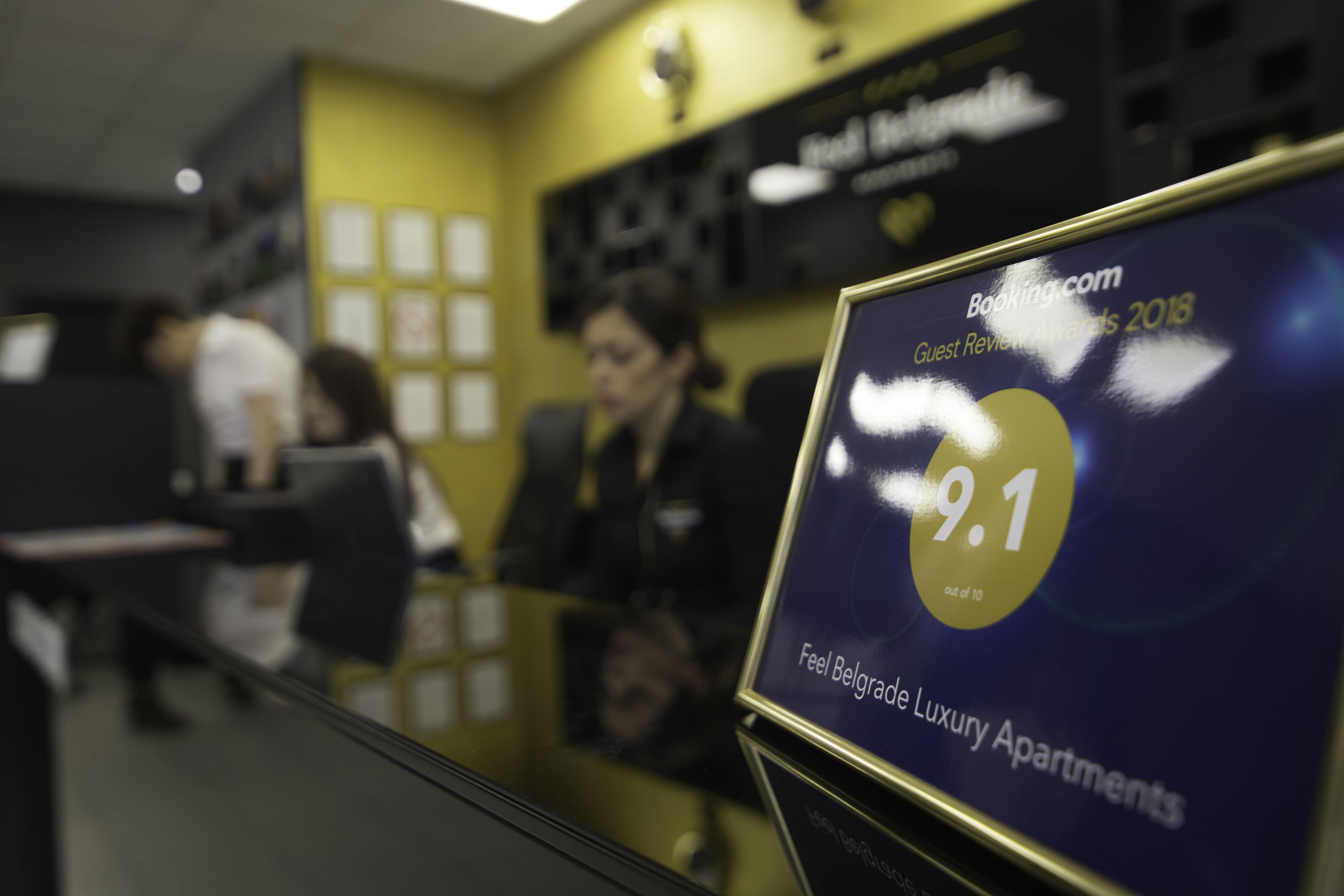 A booking display for Belgrade Luxury Apartments with a 9.1 rating.