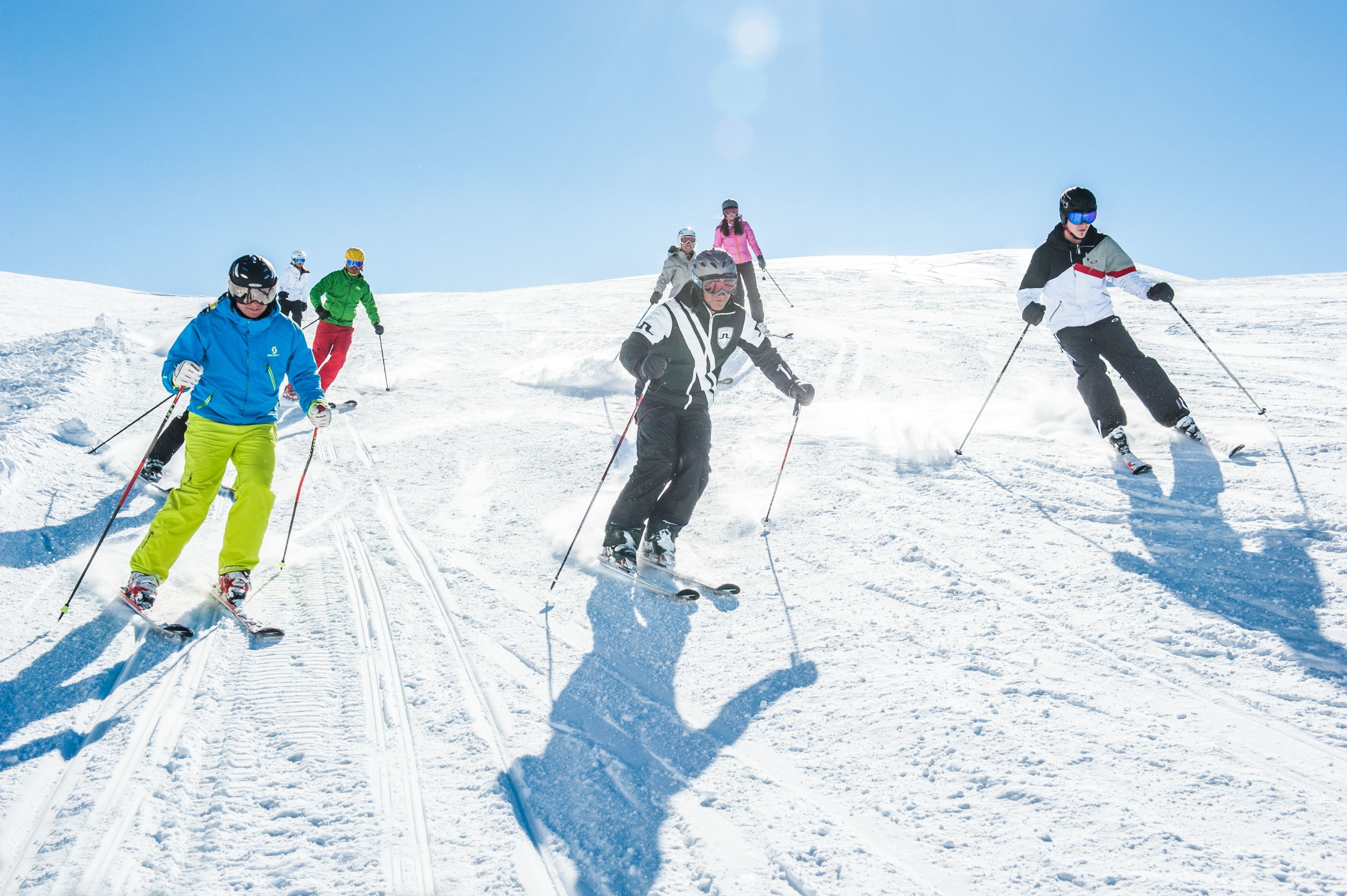A group of skiers on a snowy slope.