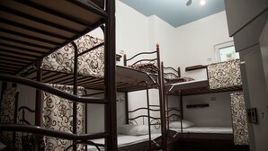 A dormitory room with bunk beds, patterned curtains, and a light fixture on the ceiling. - Z Hostel (Kyiv)
