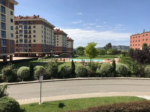 A residential building with multiple balconies, a swimming pool, and a well-maintained garden. - Apartamentos Alday (Camargo)