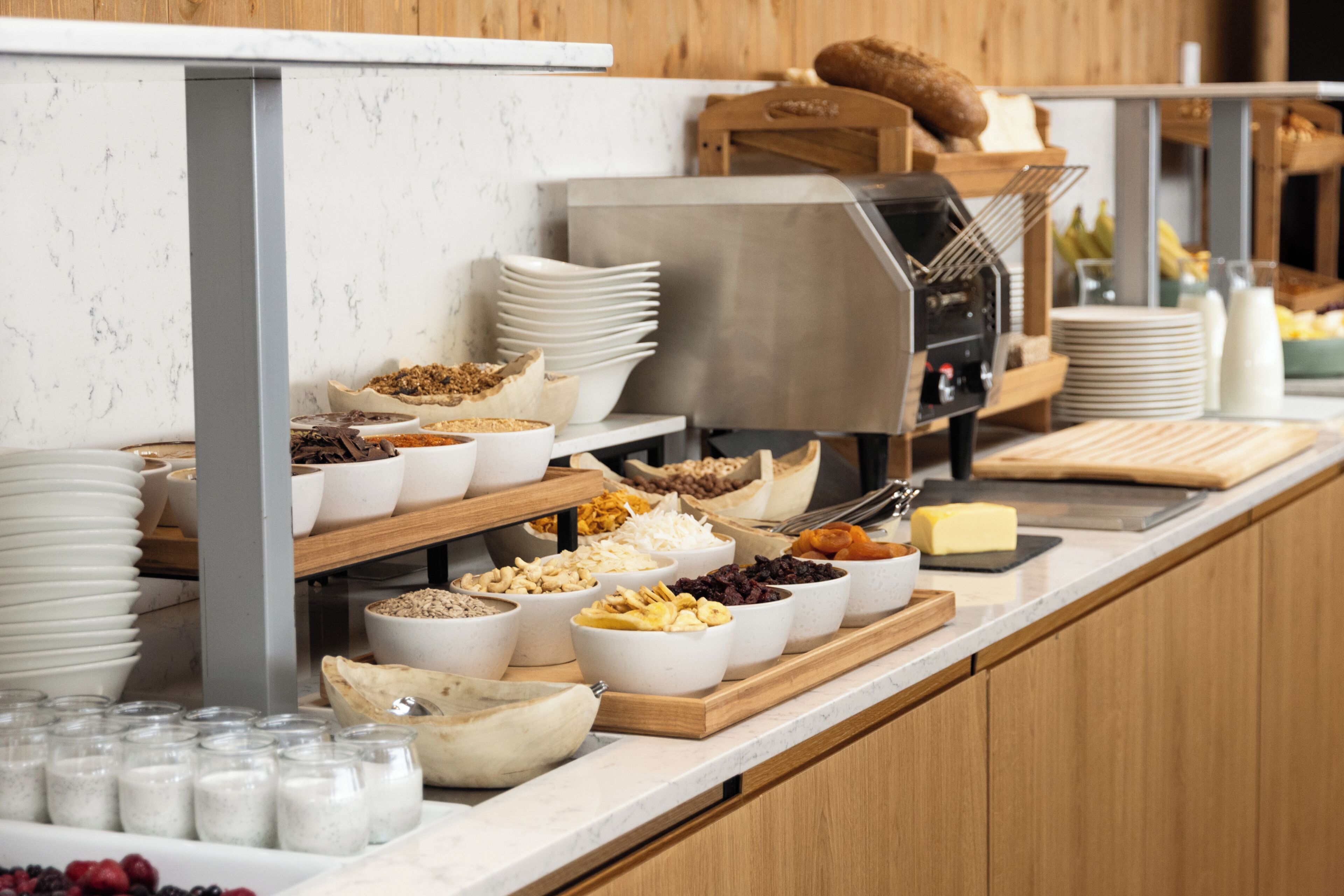 A buffet with various food items and utensils.