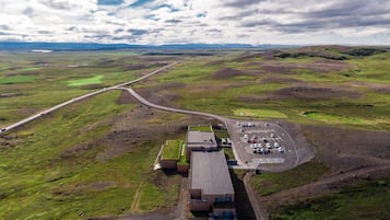 An aerial view of a parking lot with a building in the foreground.