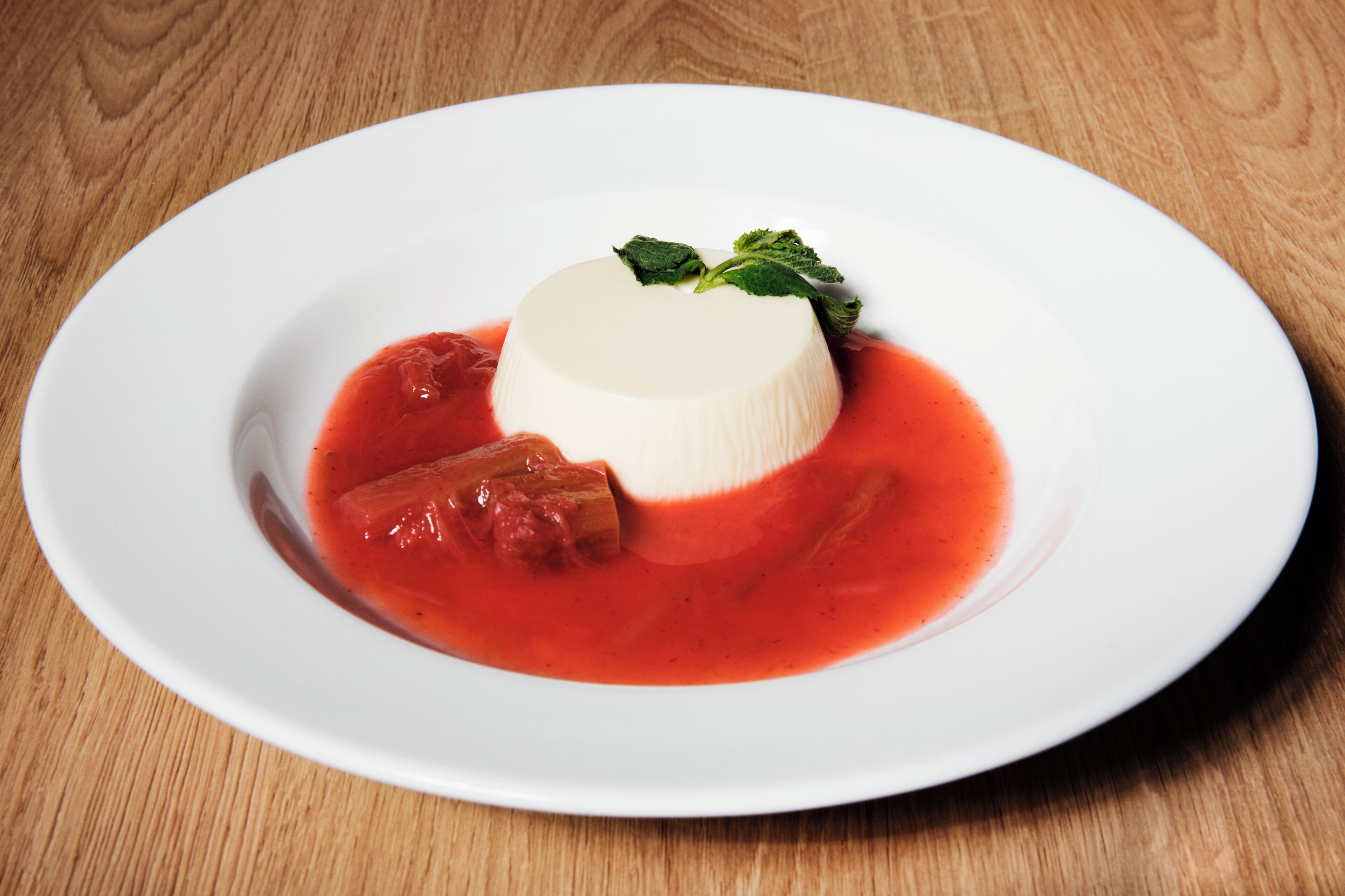 A dessert on a white plate with a wooden table background.