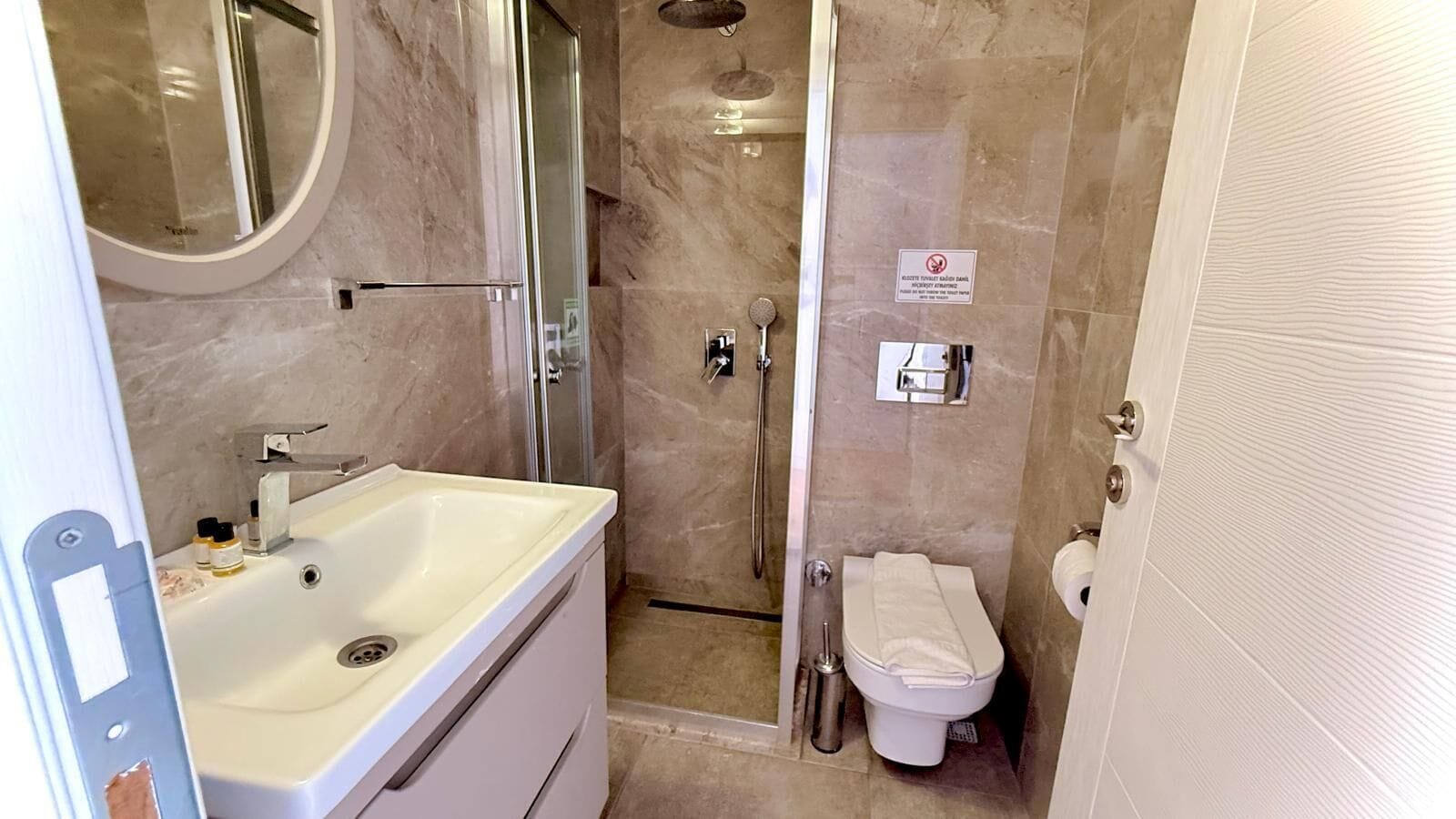 A bathroom with a sink, toilet, and shower.
