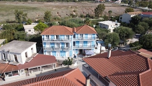 A multi-story building with a red-tiled roof, balconies, and a visible ground floor entrance. - Blue Lake (Zakynthos)