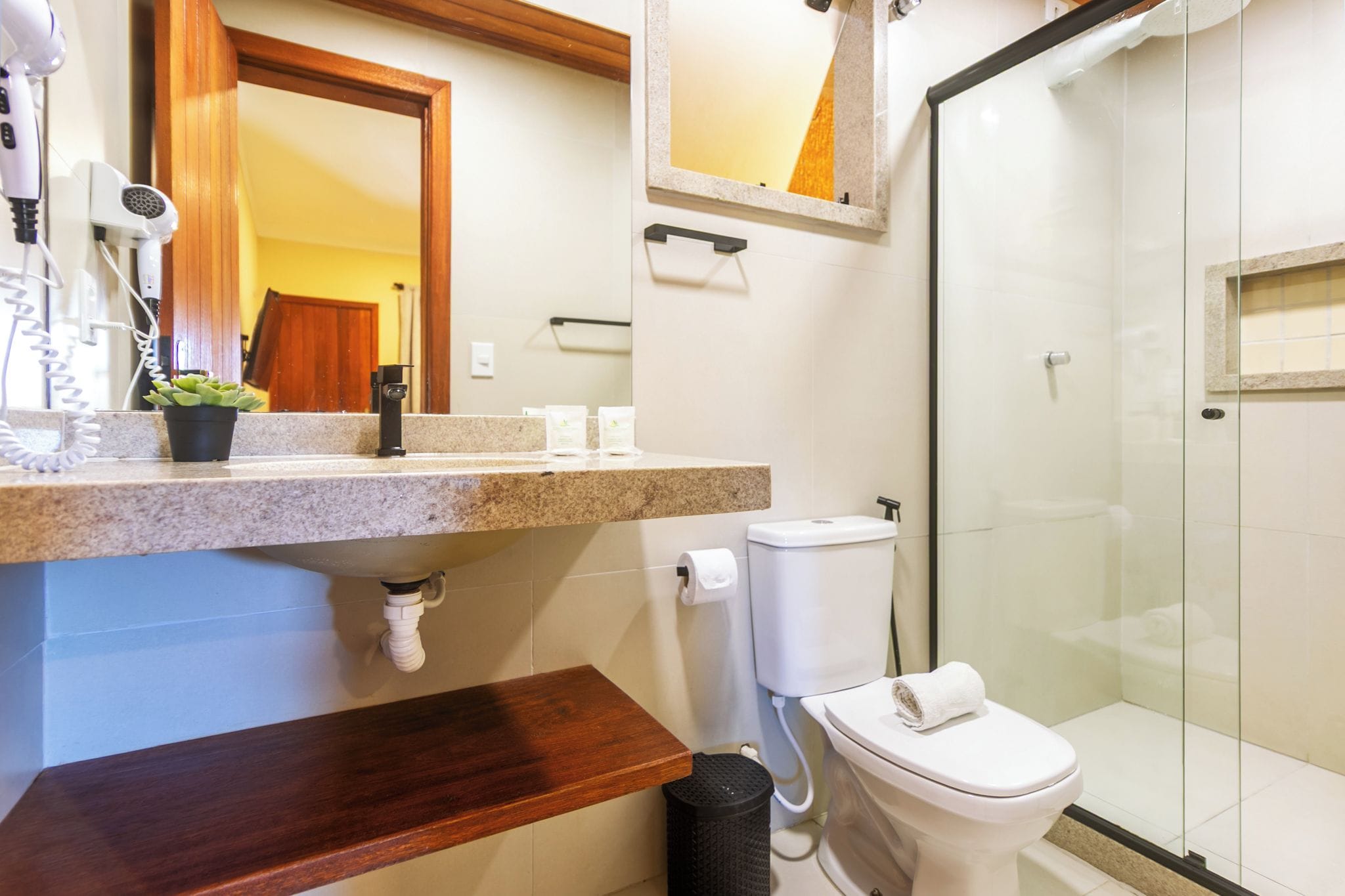 A bathroom with a shower, toilet, and sink.