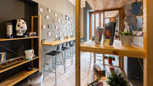 A modern café with a wooden interior, bar seating, and a wall decorated with notes and pictures. - Terrazza Santa Chiara (Catania)