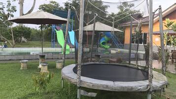 Enjoy a fun-filled day at the resort's outdoor playground, featuring a trampoline and play structures.