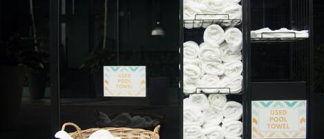A display of used pool towels in a store window.