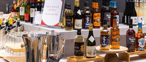 A variety of liquor bottles and glasses on display.