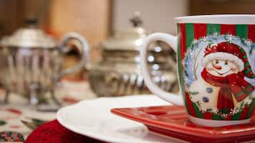 A festive table setting awaits, complete with a decorative mug and teapots, perfect for a holiday tea service.