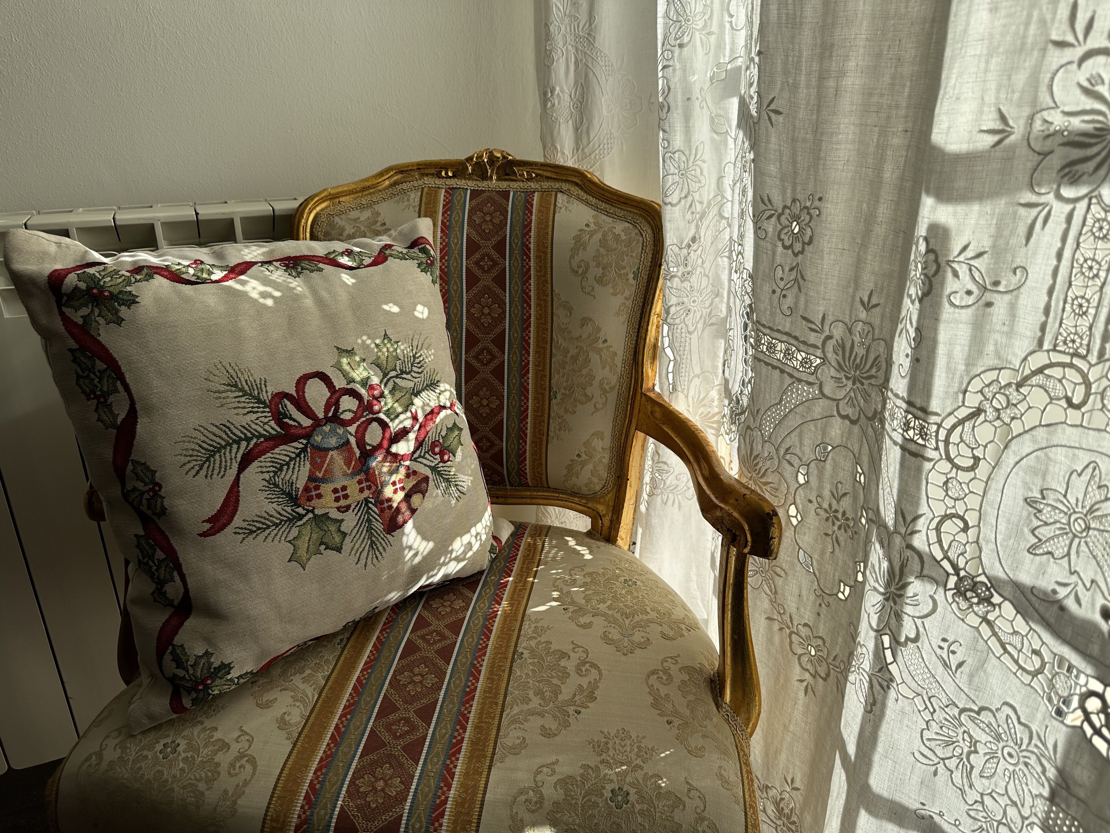 A chair with a floral cushion and a patterned fabric.