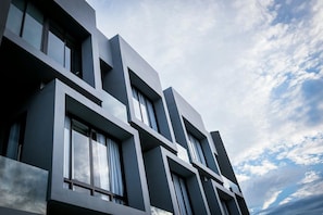 A modern building with a geometric facade and large windows. - Kalm Bangsaen Hotel (Chonburi)