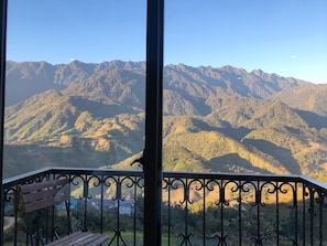 A balcony with a view of a mountainous landscape. - Sapa Odyssey Hostel (Sa Pa)