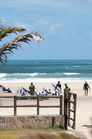 On the beach, beach shuttle, beach towels, windsurfing