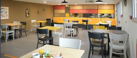 A modern cafe with multiple seating areas, including tables and booths, and a counter with a menu.