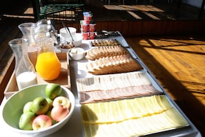 A breakfast buffet with various food items and beverages. - Casona Recoleta (Santiago)