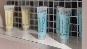 A row of bathroom shelves with tubes of bath and shower gel. - MetroStays - Stephen's Green 7-2 (Dublin)