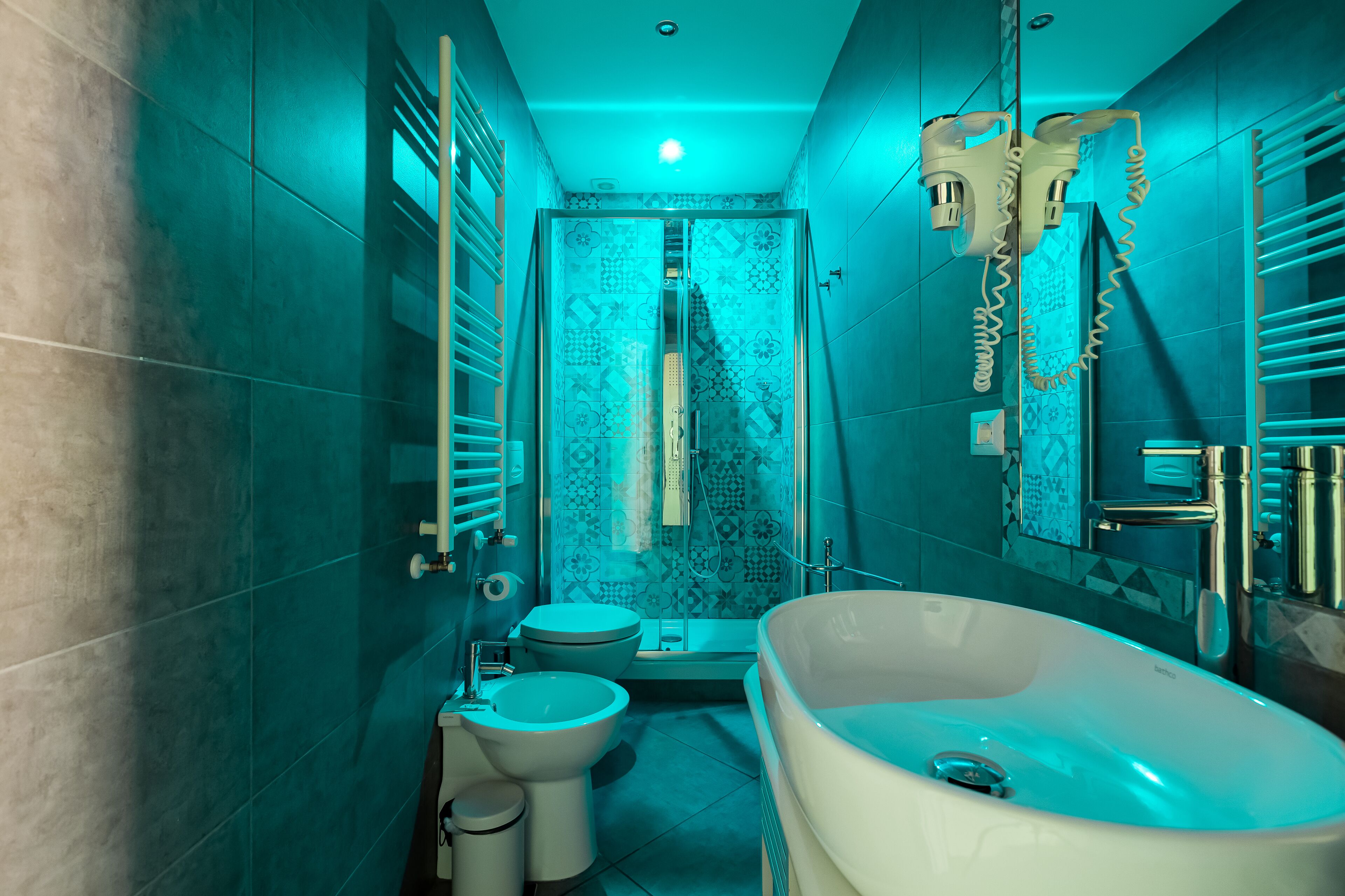 A modern bathroom with a freestanding bathtub, a toilet, and a bidet.